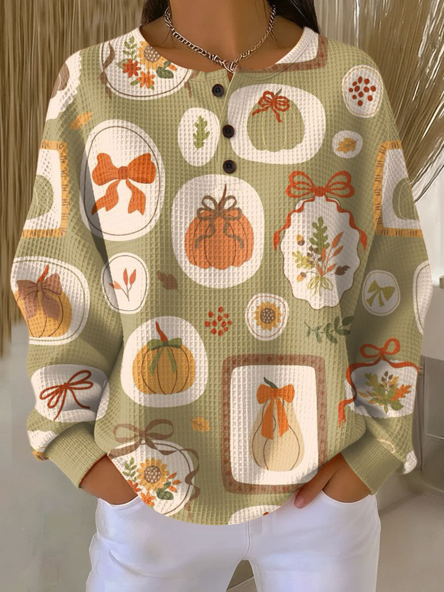 Freja | Herfsttrui met strikken en pompoenen